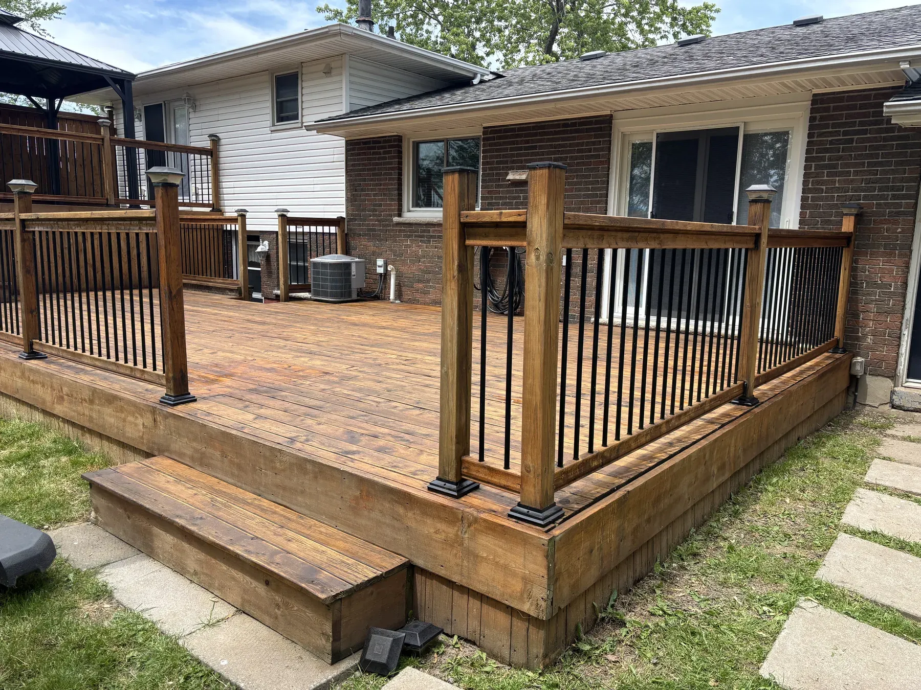 Fort Erie deck after maintenance recoat — raised gazebo corner with privacy screen