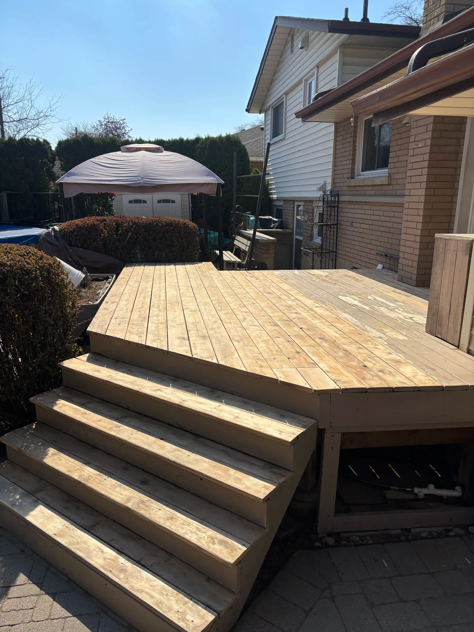 St. Catharines deck — failed paint and damaged wood close-up